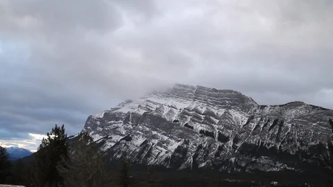 Clouds drift over a frozen mountain landscape in Alberta Stock Footage 90830172