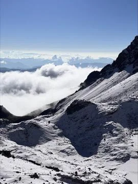 Clouds Drift Over Icy Valley Depths. Stock Photos