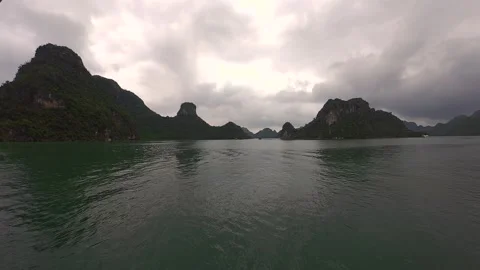 Clouds Drift Over Limestone Islands and Calm Waters in Ha Long Bay, Vietnam Stock Footage 338276622