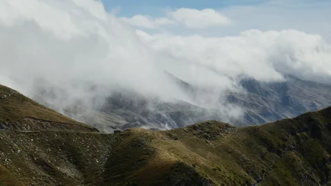 Clouds Drift Over Rolling Hills and Valleys in Remote Mountain Region Stock Footage 333977801