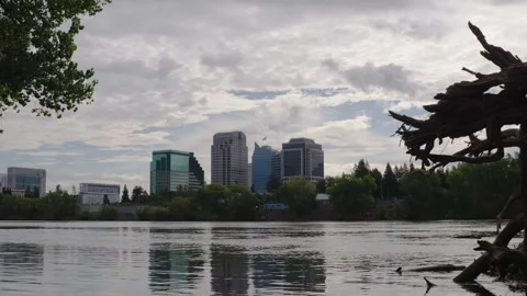 Clouds drift over Sacramento skyline and river in daytime timelapse Stockbeeldmateriaal 344502111