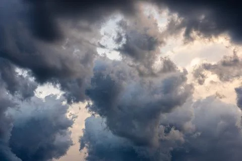 Clouds drift overhead in a sky filled with color and contrast, creating a dra Stock Photos