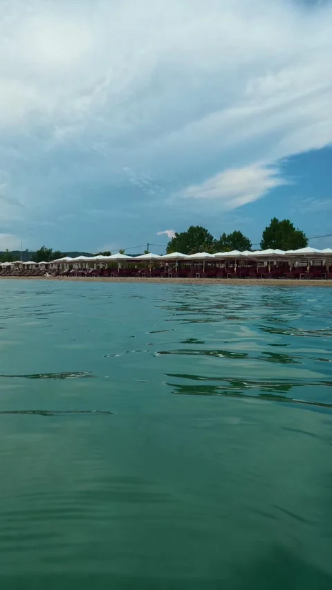 Clouds drift slowly above the distant shoreline. Trani Ammouda, Vertical Stock Footage 340650644
