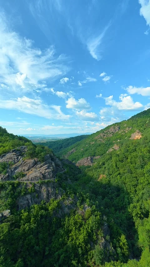 Clouds drift slowly across the vast horizon. Sokolica rock, Serbia. Vertical Stock Footage 341131989