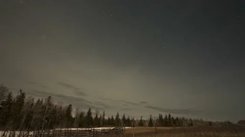 Clouds drift through a night sky filled with stars. Stock Footage 151116341