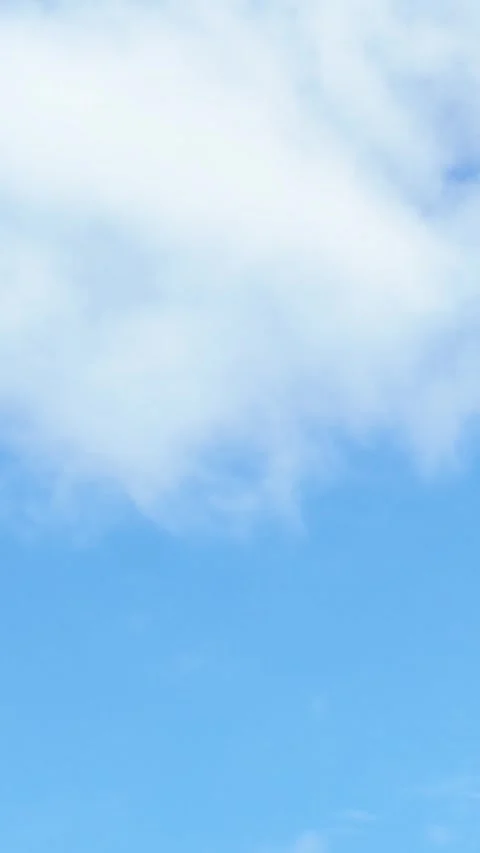 Clouds Drifting Across Blue Sky vertical video Stock Footage 340547921