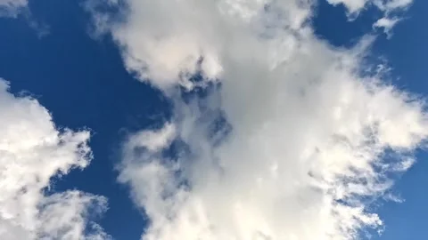 Clouds drifting across blue summer sky in daylight view Stock Footage 317290685
