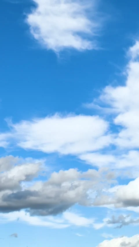 Clouds drifting across bright blue daytime sky. Timelapse Stock Footage 331222028