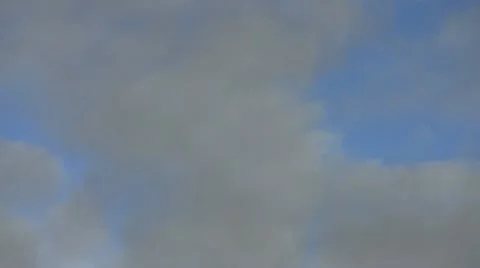 Clouds drifting in a blue sky Stock Footage 10710887