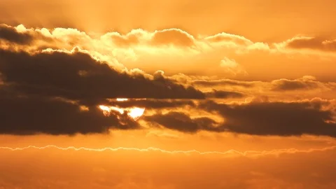 Clouds drifting in front of sunset in realtime 動画素材 97455961