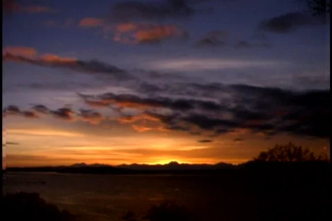 Clouds drifting in golden sky Stock Footage 564761