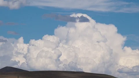 Clouds drifting, melting and growing in clear blue sky Stock Footage 77177388