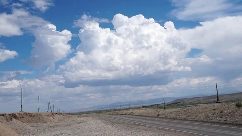 Clouds drifting, melting and growing in clear blue sky Stock Footage 77182306
