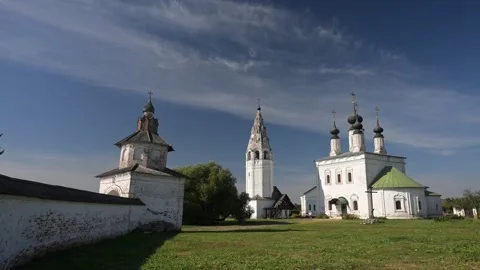 Clouds drifting over an ancient monastery with white walls and green roofs Vídeo Stock 288634090