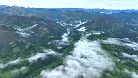 Clouds drifting over green mountain ranges and valley at dawn Stock-Footage 341327933