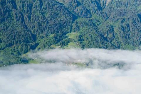 Clouds drifting over lush alpine hillside Stock Photos