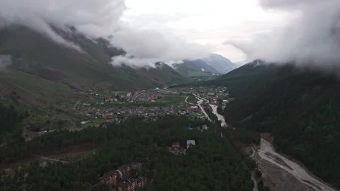 Clouds drifting over a picturesque mountain valley town Stock Footage 289657656