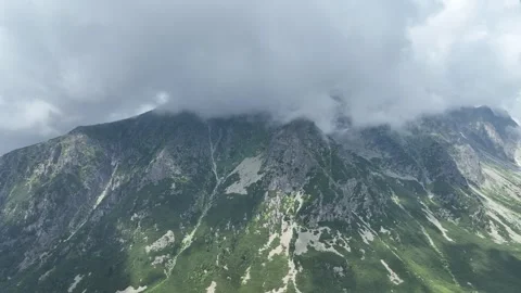 Clouds drifting over a rugged alpine mountain ridge Stock Footage 345167249