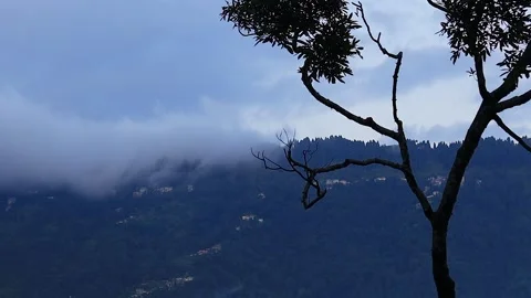Clouds drifting over slopes of himalayan hill town with small houses during.. Stock Footage 305531412