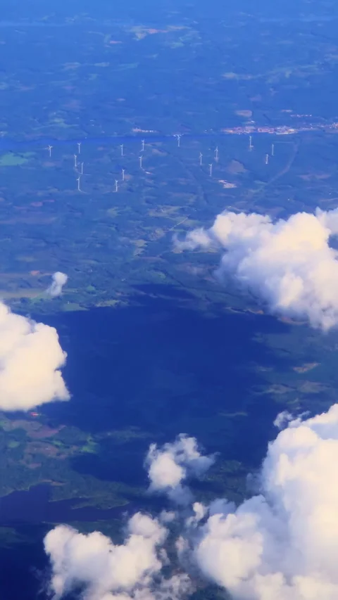Clouds drifting over wind farm on lake shore Stock Footage 289222977