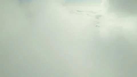 Clouds drifting softly over a serene landscape at sunrise 스톡 동영상 312857607