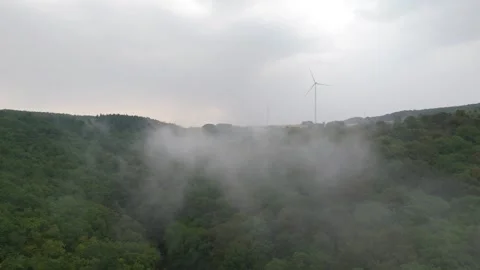 Clouds drifting through forested Hunsrück valley with turbines Vídeos de archivo 340367802