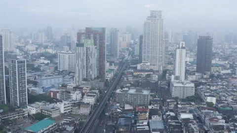 Clouds drone birds eye view of BTS skytrain on Sukhumvit street in Bangkok, the Stock-Footage 228804342