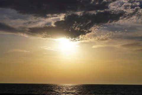 Clouds during sunset at sea Stock Photos