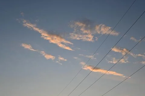 Clouds in a dusk sky with power lines Stock Photos