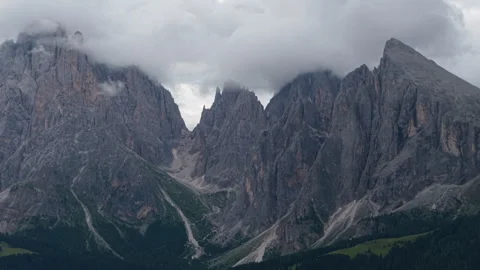 Clouds embracing the Dolomites peaks in Alpe di Suisi, Italy Stock Footage 314940551