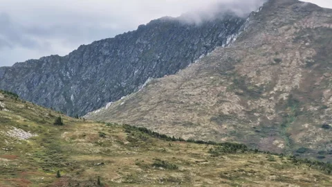 Clouds embracing mountain peak: a serene landscape Stock Footage 300934763