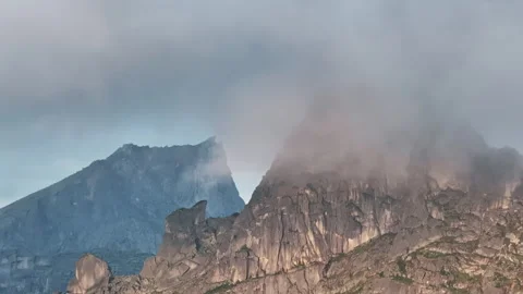 Clouds embracing mountain peaks: a captivating sequence Stock-Footage 300905224