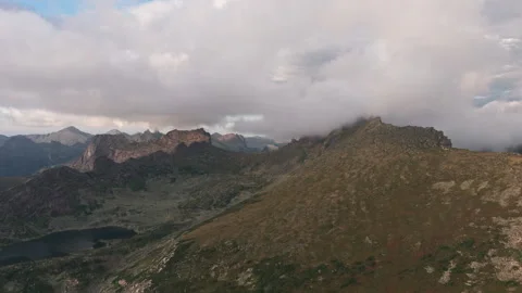 Clouds embracing mountain peaks in a cloudy landscape Stock Footage 300901680