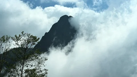 Clouds envelop a mountain peak Stock Footage 126120820
