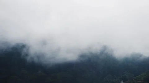 Clouds envelop the mountain slopes Video stock 151958571