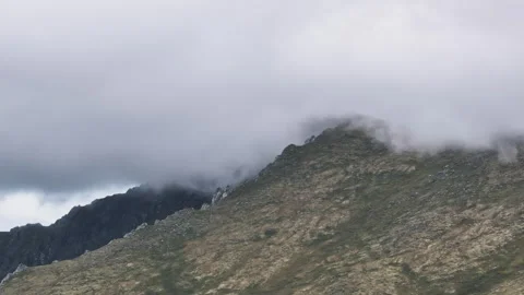 Clouds enveloping a mountain peak Stock Footage 300930327