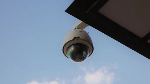 Clouds: Establishing Shot of a Round CCTV Camera Monitoring Building in Daylight Stock Footage 243382771