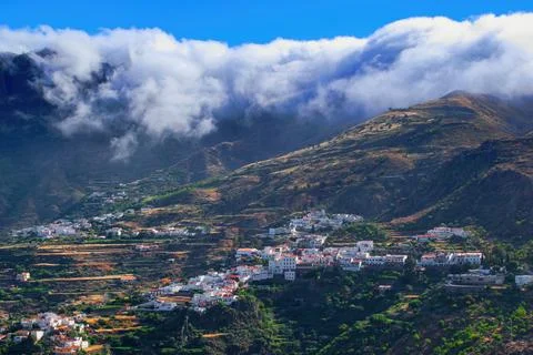 Clouds falling over the mountain ridge above village Tejeda, Gran Canaria, Ca Фото