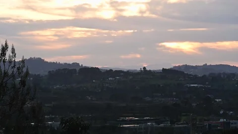 Clouds in fast motion over green landscape of hills and a village. Europe n.. Stock Footage 231569922