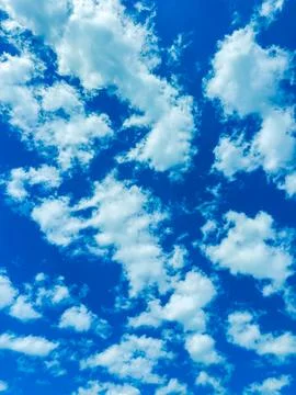 Clouds fill the sky during the day showing various shapes and patterns in a.. 写真素材
