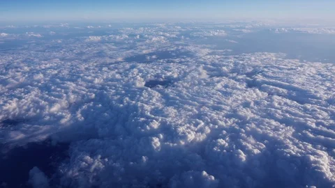 Clouds filmed from above; white clouds seen from a flying plane above them Stock Footage 121912142