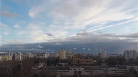 Clouds float above city district in spring timelapse Stock Footage 77285142