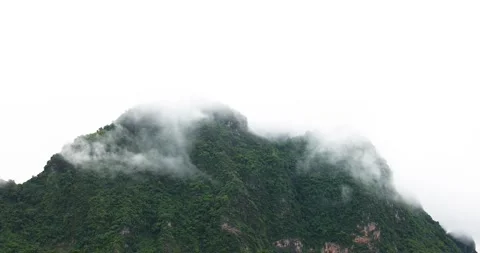 Clouds float above the green mountains covered with morning mist after the rain. Stock Footage 314692664