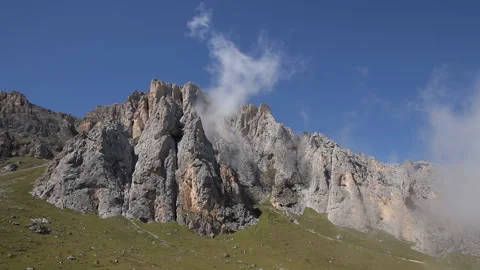Clouds float above the mountain peaks. Stock Footage 97763362