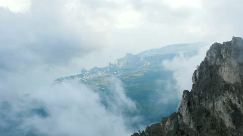 Clouds float above the mountain village. Video stock 97739516
