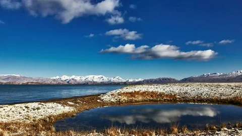Clouds float above the salty lake.  Pamir highway. Tajikistan. summer time Stock Footage 70894372