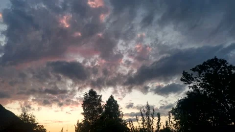 Clouds float across the sky at sunset Stock Footage 201808421