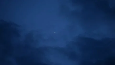 Clouds float against the background of a lone star in the twilight close-up, Stock Footage 131907551