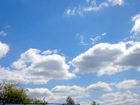 Clouds Float Against a Bright Blue Sky During the Day in a Clear Atmosphere Stock Photos
