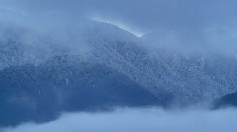Clouds float with mountains in the background. Stock Footage 33376312